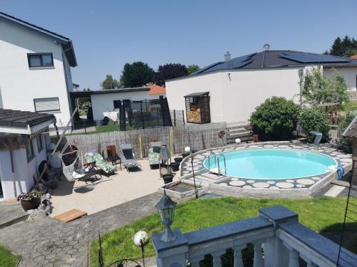 a backyard with a swimming pool and a house at FeWo-AdOlTi in Nittenau