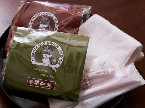 a bag of cheese and towels on a table at Suikoen in Kawanehon
