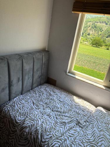 a bed in a room with a window at Stani i Metes-Bujtina Sebisht in Sebisht