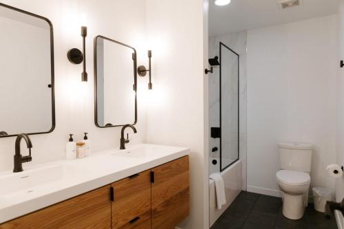 a bathroom with a sink and two mirrors at Nature Link Resorts in Nisswa
