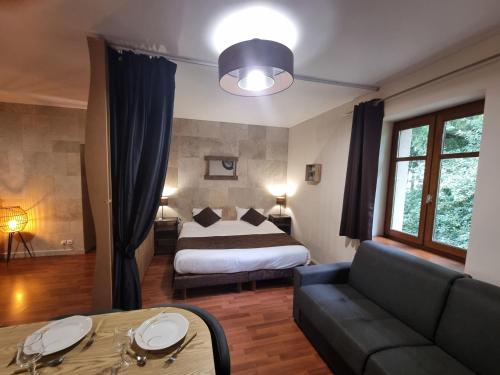 Ένα ή περισσότερα κρεβάτια σε δωμάτιο στο Hôtel du Moulin de la Brevette