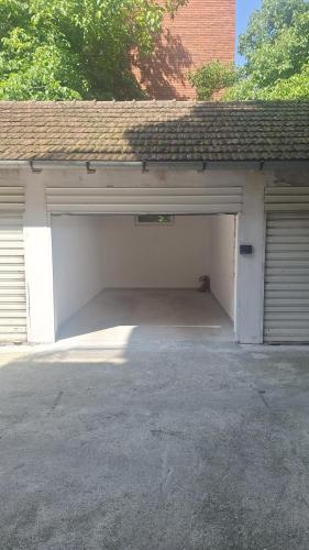 a garage with two garage doors and a roof at PORTOFINO, With Free Private GARAGE in Novi Sad