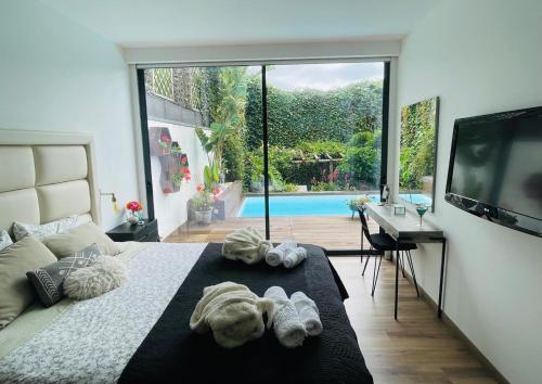 a bedroom with a large bed with towels on it at The Green Retreat in Torres Vedras
