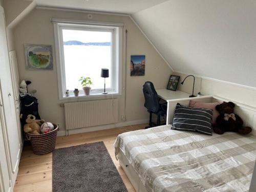 a bedroom with a bed and a window and a desk at Fantastic location on the West Coast, Bohuslän! in Ljungskile