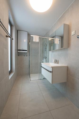 a bathroom with a sink and a shower at Villa Aquamarine Apartments in Novalja