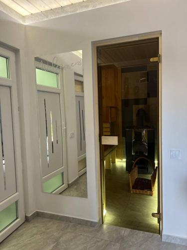 a room with a glass door and a mirror at Карпатська Модрина in Kosiv