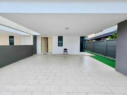 a empty hallway with a chair in a building at Cozy Villa - Private Pool, 5BR, KTV, BBQ, PS5 just 3 Mins to Batu Ferringhi Beach! in Batu Ferringhi