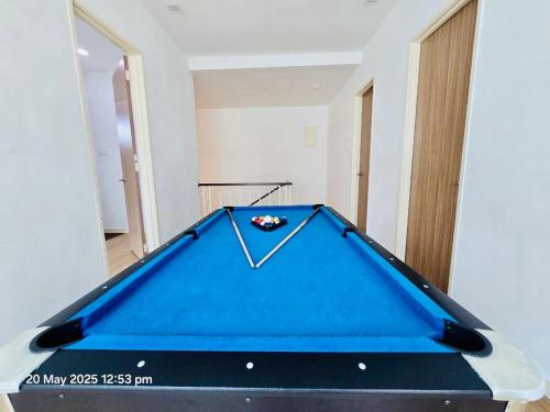 a pool table in the middle of a room at Cozy Villa - Private Pool, 5BR, KTV, BBQ, PS5 just 3 Mins to Batu Ferringhi Beach! in Batu Ferringhi