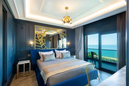 a bedroom with a large bed with a view of the ocean at MAVİ MARİN BOUTIQUE HOTEL in Ordu