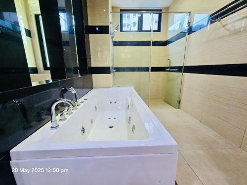 a bathroom with a large white sink and a mirror at Cozy Villa - Private Pool, 5BR, KTV, BBQ, PS5 just 3 Mins to Batu Ferringhi Beach! in Batu Ferringhi