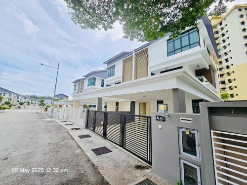 a building with a fence in front of a street at Cozy Villa - Private Pool, 5BR, KTV, BBQ, PS5 just 3 Mins to Batu Ferringhi Beach! in Batu Ferringhi