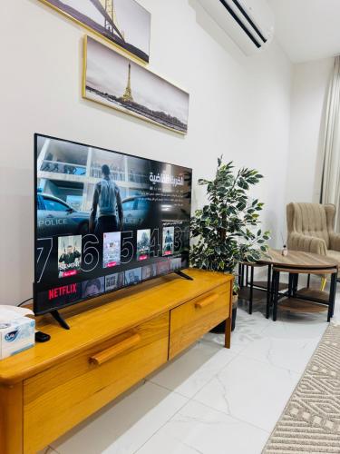 a living room with a large flat screen tv at NEW VIP FLAT in Murooj Al Zain, Salalah in Salalah