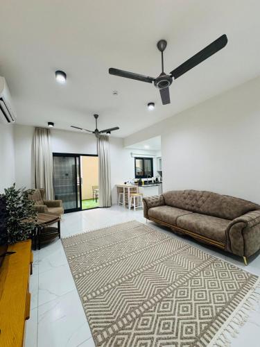 a living room with a couch and a rug at NEW VIP FLAT in Murooj Al Zain, Salalah in Salalah