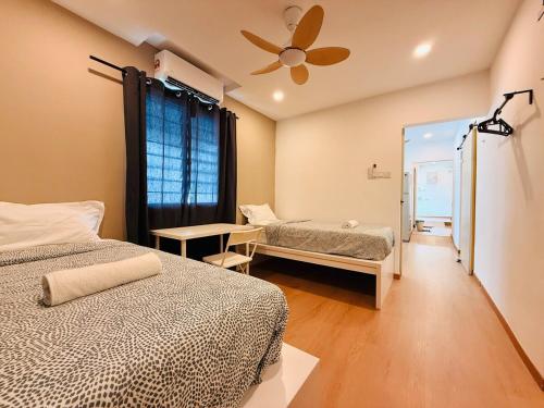 a bedroom with two beds and a ceiling fan at WhiteZen Family Homestay 9Room for 20pax Central Penang in Jelutong