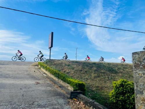 a group of people riding bikes down a hill at Tissa Yala Lake View Hotel in Tissamaharama