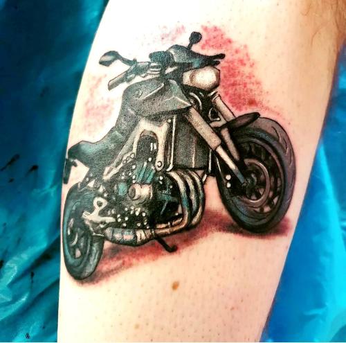 a motorcycle tattoo on the arm of a person at Tattoo PENSION mit Restaurant und Tattoo-Studio in Mörtschach