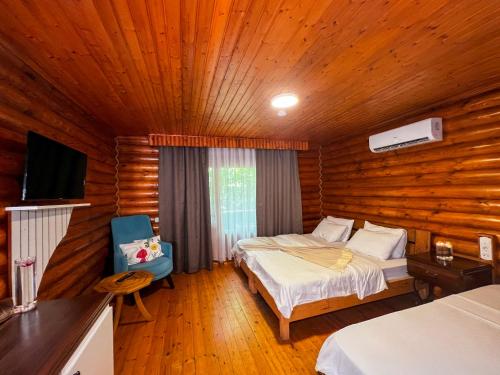 a bedroom with two beds and a television in it at Woodline Hotel in Kemer