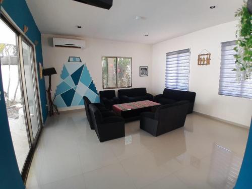 a living room with a couch and a table at Casa los fundadores 24 7 Security Private Pool Service Included in Playa del Carmen