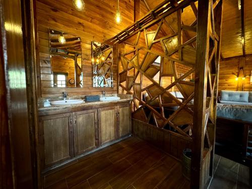 a wooden bathroom with a sink and a mirror at شاليهات ديلان in Riyadh