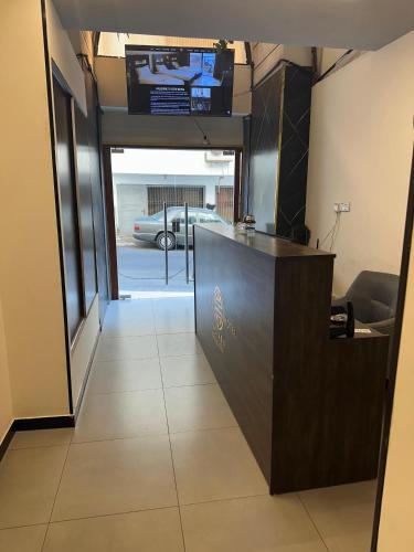 a lobby with a reception desk with a car outside at Eden Hotel in Aqaba