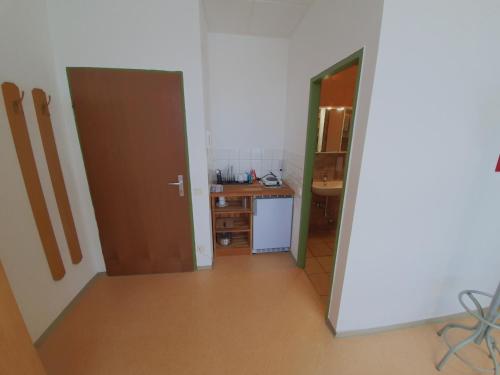 a room with a hallway with a desk and a door at Zirbitzblick in Zeltweg