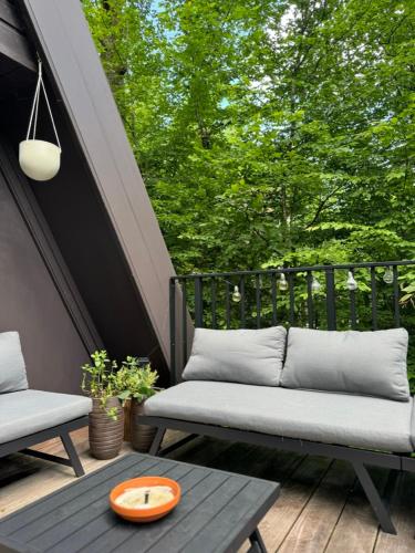 a patio with a bench and a table and trees at A - (frame) - Like A dream in Durbuy
