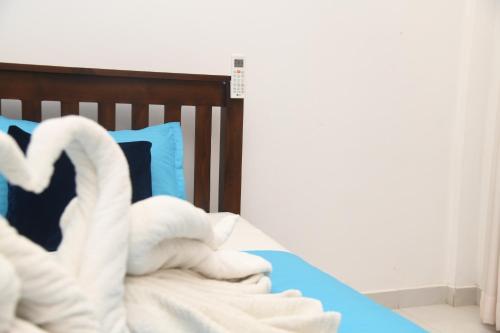 a bed with two swans made out of towels at Traget safari home stay in Udawalawe