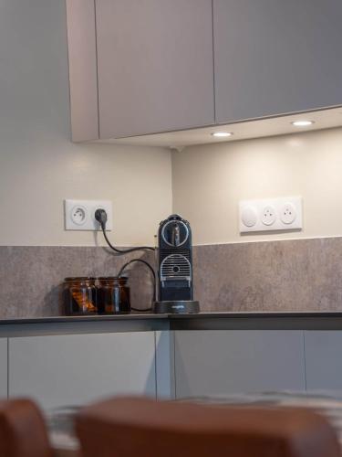 a kitchen counter with a sink and a pot at Les chambres de la Marquise in Martel