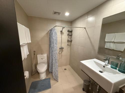 a bathroom with a toilet and a sink at HAVEN on the 28th in Manila