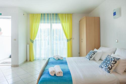 a bedroom with a large bed with towels on it at Apartments Barbara in Trogir