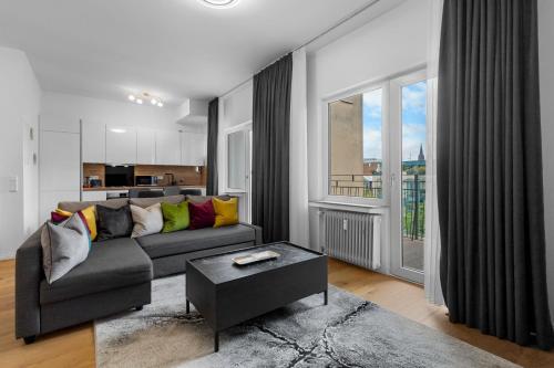 a living room with a couch and a table at Domloge Lofts & Apartments in Cologne