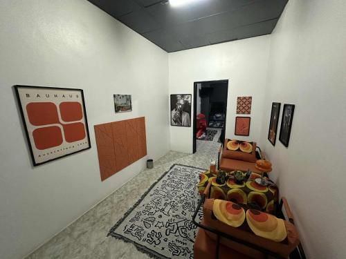 a room with paintings on the wall and a room withartifactsartifacts at Andaman Genetics 420 Rooms in Ao Nang 