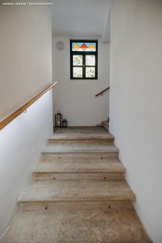 a staircase in a house with a window at Penzion Za Stromem in Opočno
