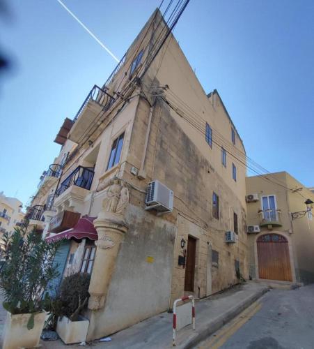 an old building on the side of a street at Melita Seafront Guesthouse- Room 11 in Marsaskala