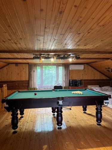 a pool table in a room with a ceiling at Карпатська Модрина in Kosiv