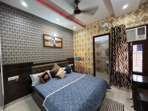 a bedroom with a blue bed and a shower at Entire 3bhk Luxury Flat in Zirakpur-Panchkula-Chandigarh-Mohali, Punjab, India in Zirakpur