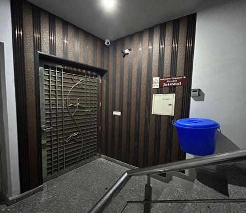 a door in a building with a blue trash can at Entire 3bhk Luxury Flat in Zirakpur-Panchkula-Chandigarh-Mohali, Punjab, India in Zirakpur