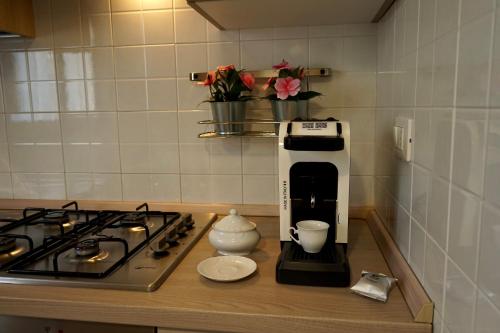 a coffee maker on a counter next to a stove at Manoppello Scalo Two-room apartment & parking in Brecciarola