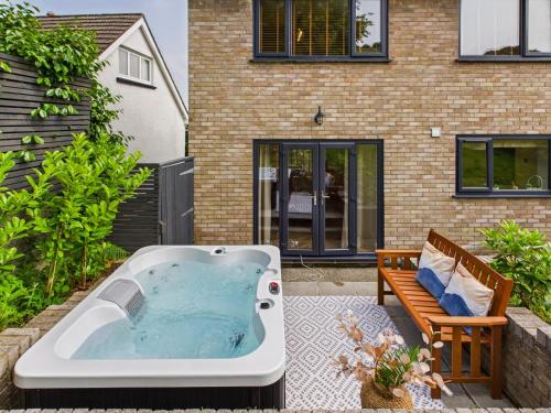 a hot tub in the backyard of a house at 5-Bed Retreat with Hot Tub, Garden & Relaxing Views in Burry Port