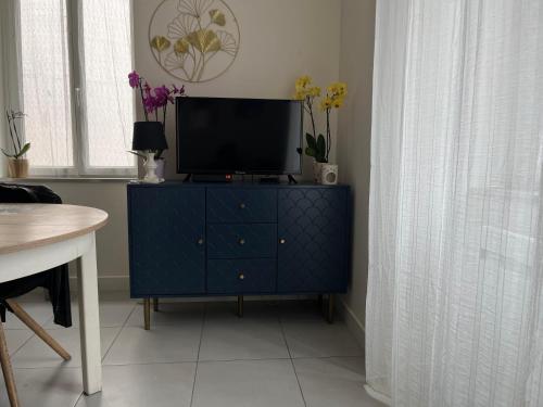 une commode bleue avec une télévision dessus dans une pièce dans l'établissement Garaldia, à Cambo-les-Bains