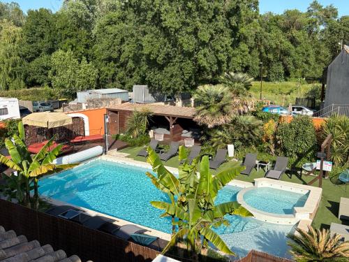 an overhead view of a swimming pool with chairs and trees at GuestHouse Le Patio34 in Lavérune