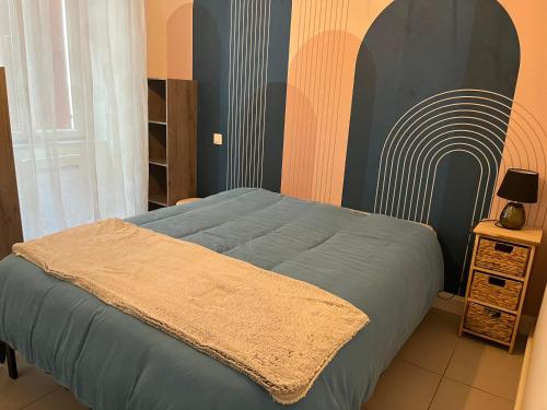 une chambre avec un lit avec une couverture dessus dans l'établissement Garaldia, à Cambo-les-Bains