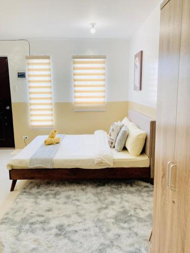 a bedroom with a bed with two stuffed animals on it at Asahels Cozy Crib 2,WiFi Nflix in Palo