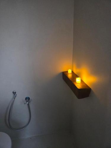 a bathroom with a sink and a light on the wall at DarAK in Tazarka