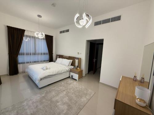 a bedroom with a white bed and a large window at 3BR Amazing Seaview Private Villa with Pool in Fujairah