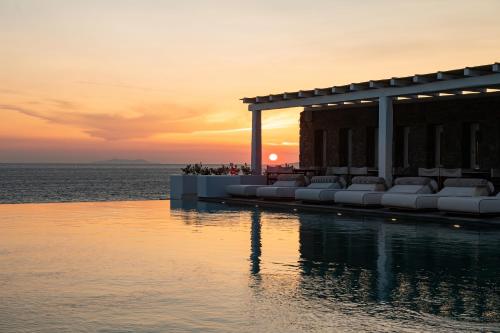 a sunset over the water at a resort at Porto Mykonos in Mýkonos City