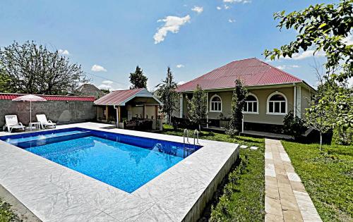 a swimming pool in the yard of a house at Courtyardqabala in Gabala