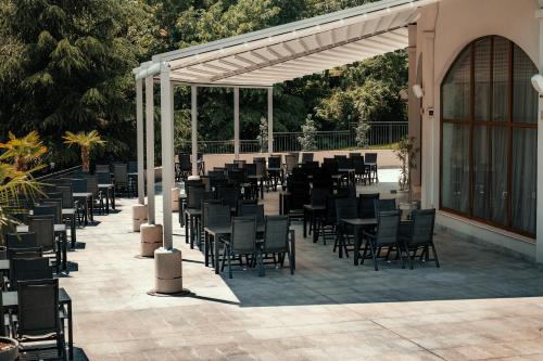 a group of chairs and tables on a patio at Hotel Continental in Golden Sands