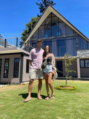 a man and a woman standing in front of a house at The Chapter in Nuwara Eliya