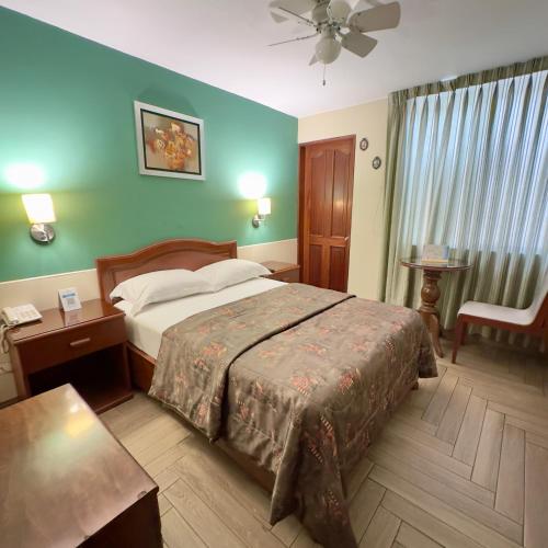 a hotel room with a bed and a table at Hotel La Molina in Lima